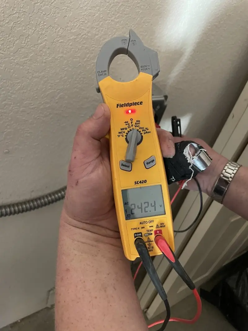 Voltage testing with clamp meter during Outlet Installation in Flint